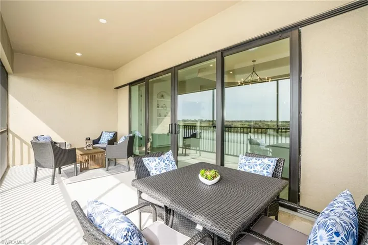 Balcony featuring outdoor lounge area and a water view