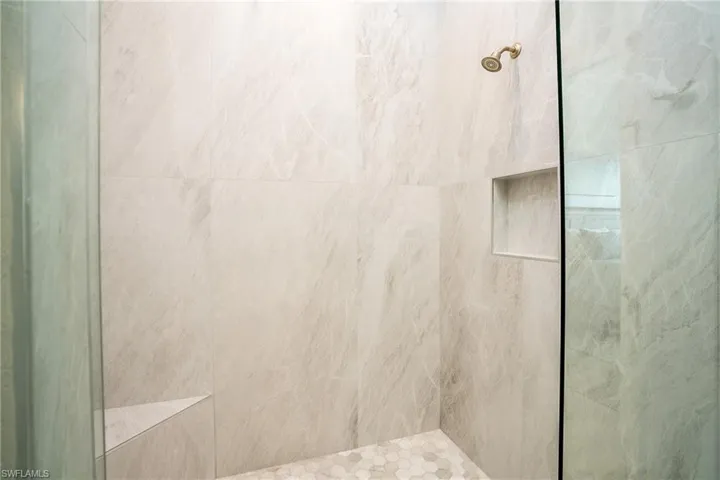 Full bath featuring tiled shower