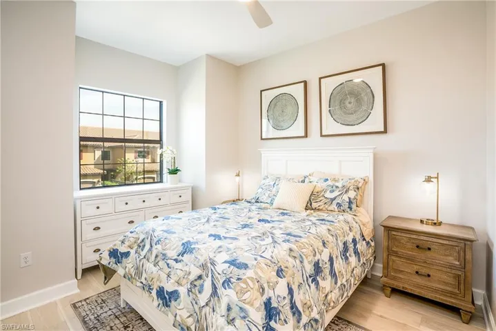 Bedroom with light wood-style flooring and a ceiling fan