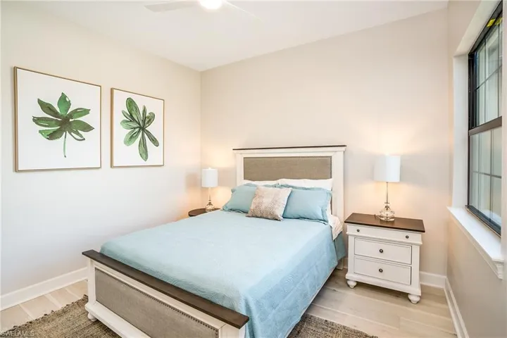 Bedroom with light wood-style floors and a ceiling fan