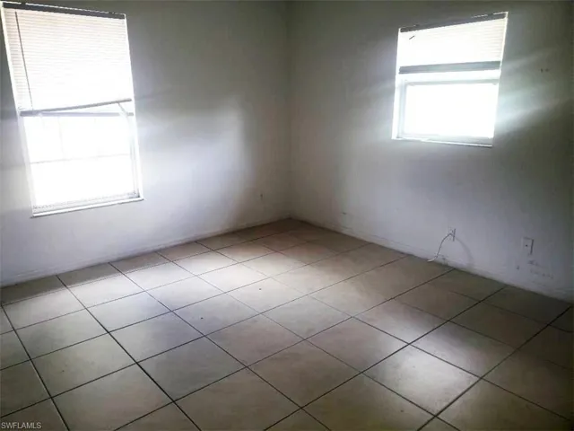 Empty room featuring light tile patterned floors