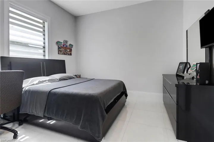 Bedroom with light tile patterned flooring