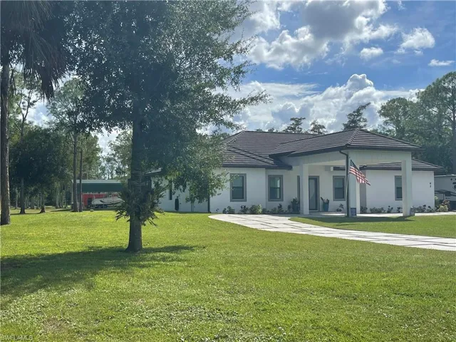 Single story home featuring a front lawn and stucco siding