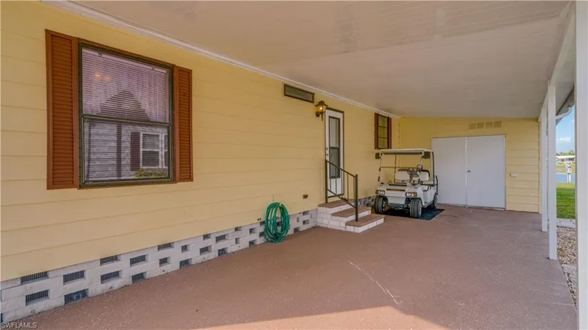 The extended carport offers much undercover space. Yes; the golf cart conveys!