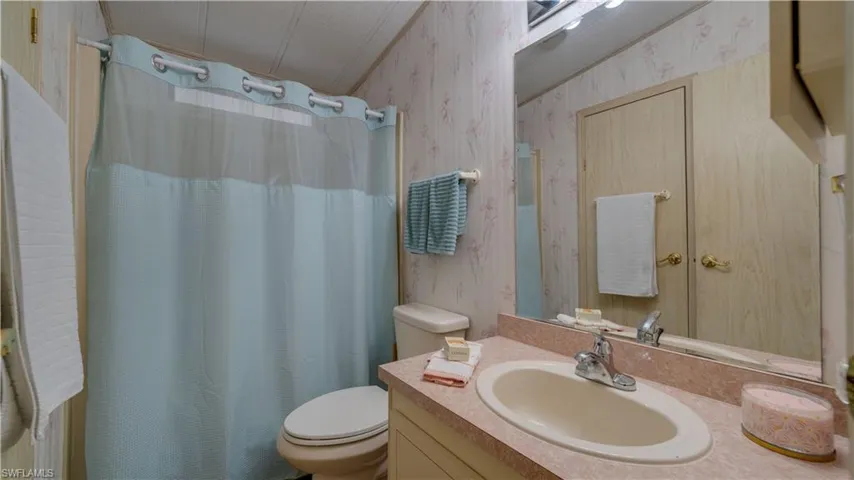 Neat and tidy; the guest bath is warm and inviting. Raised toilet? Of course.