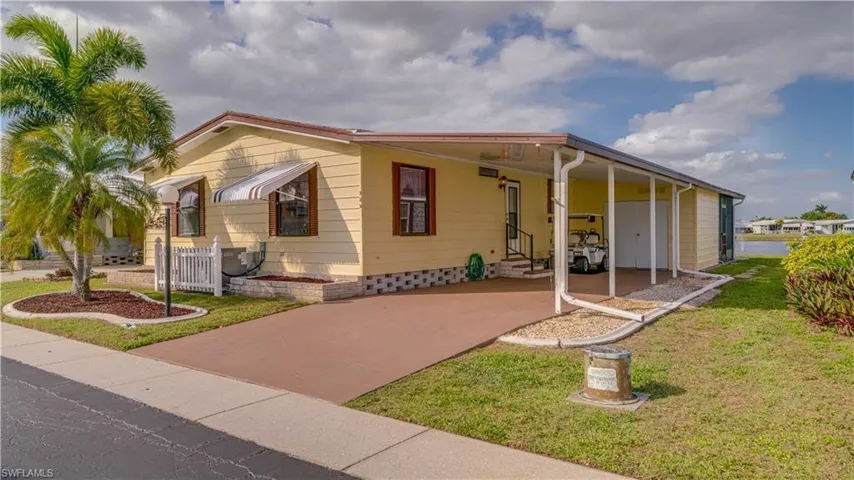 Clam shell shutters surround the home. Accordian hurricane shutters protect the lakeside of the home.