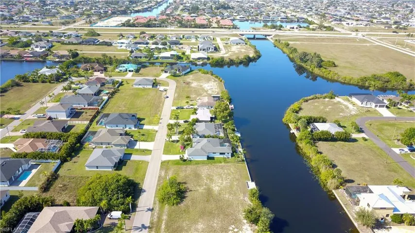 Aerial view of property's location featuring nearby suburban area and a nearby body of water