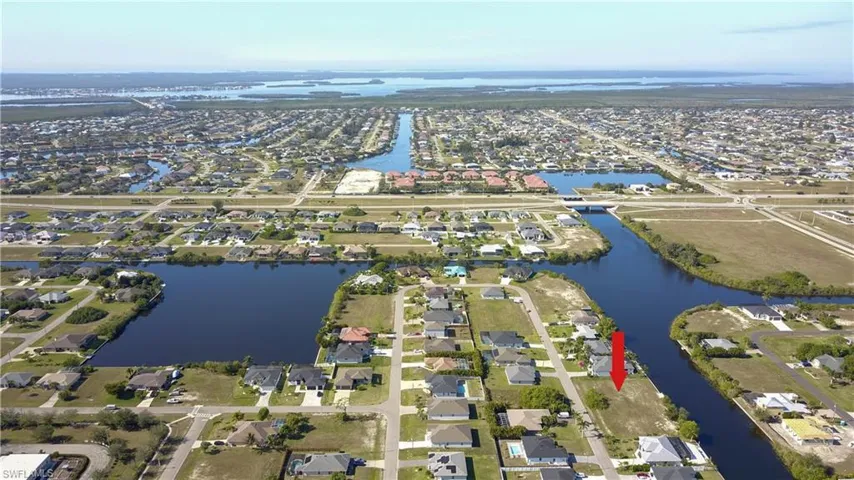 View of property location featuring a nearby body of water and nearby suburban area