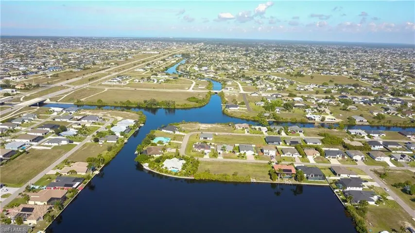 Aerial overview of property's location with nearby suburban area and a nearby body of water