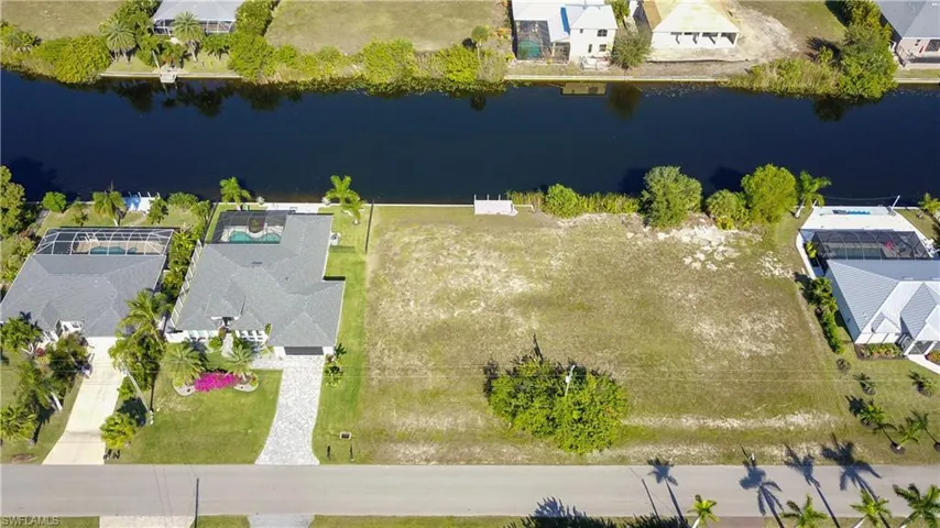 Aerial view of residential area featuring a large body of water