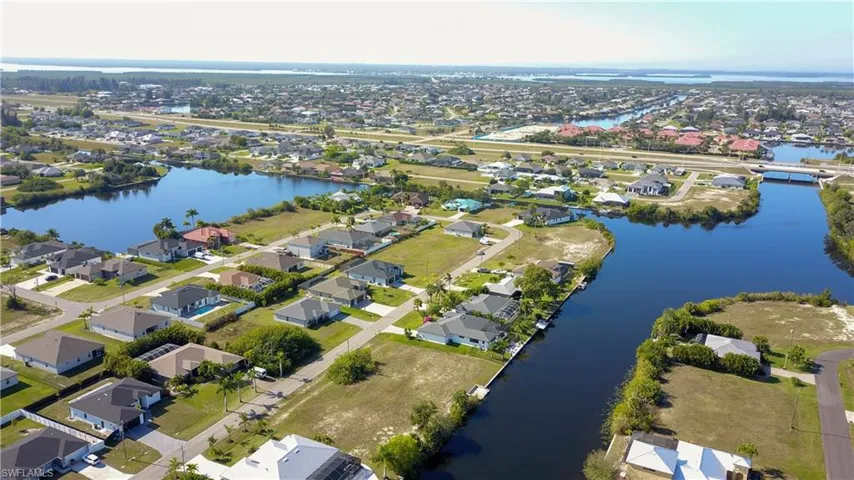 View of property location featuring a large body of water and nearby suburban area