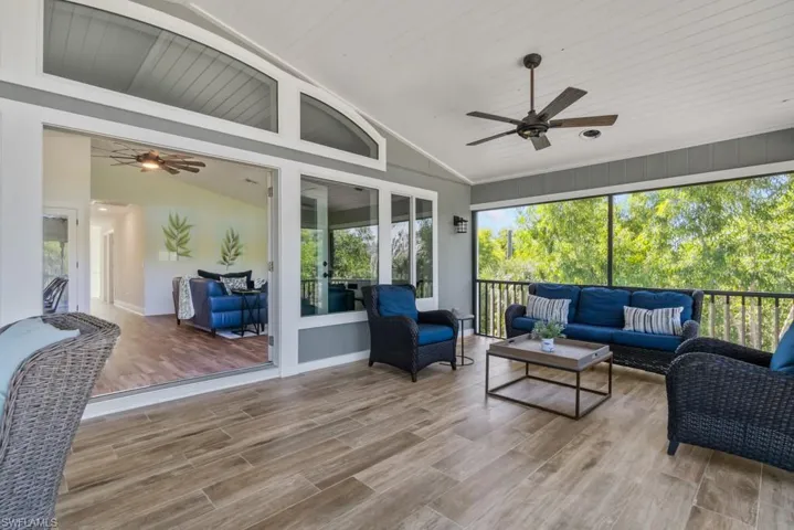 Sunroom featuring ceiling fan and vaulted ceiling