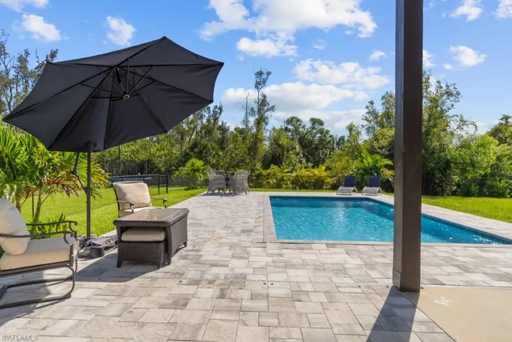 View of swimming pool featuring a yard and a patio area