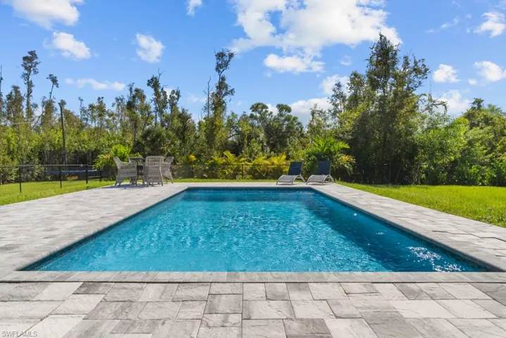 View of swimming pool featuring a yard and a patio area
