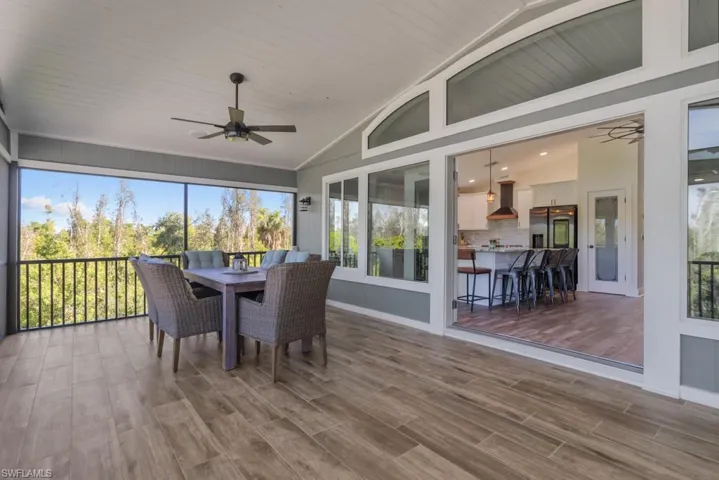 Sunroom / solarium featuring ceiling fan and lofted ceiling