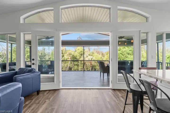 Doorway to outside featuring ceiling fan and hardwood / wood-style floors