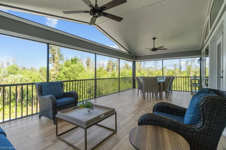 Sunroom featuring ceiling fan and vaulted ceiling