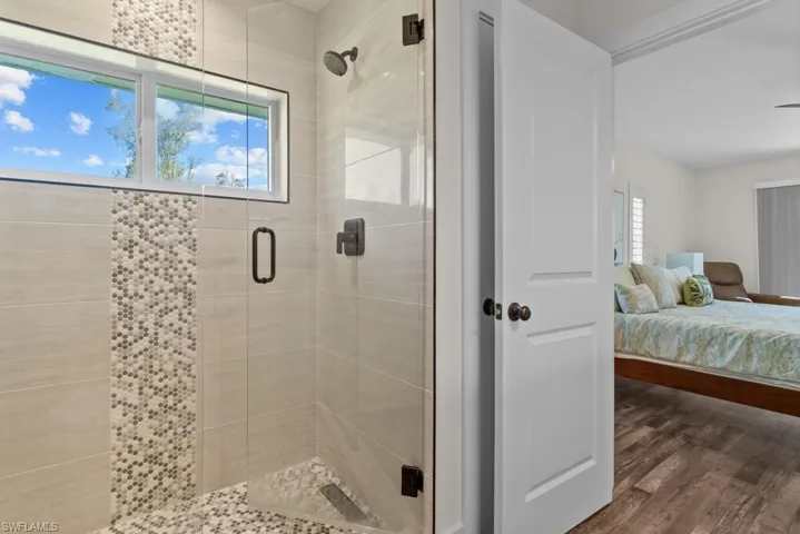 Bathroom featuring wood-type flooring and walk in shower