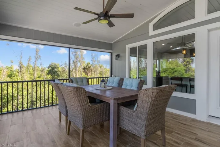 Sunroom / solarium with lofted ceiling and ceiling fan