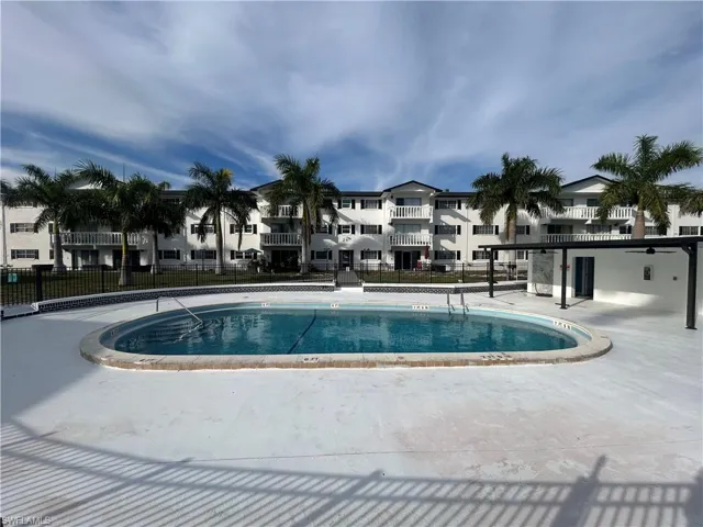 Community pool featuring a residential view and a patio