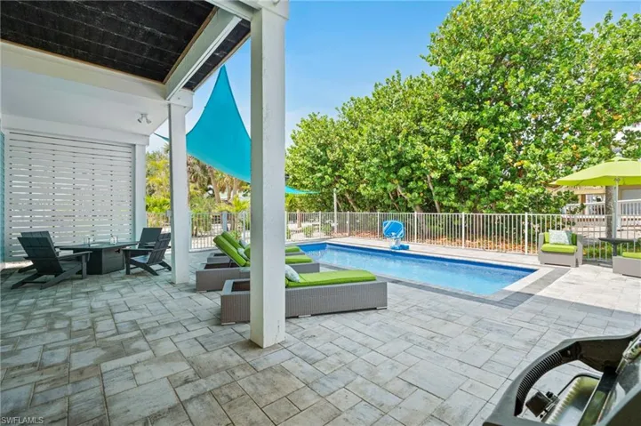 Patio, fire table and fenced in heated salt-water pool