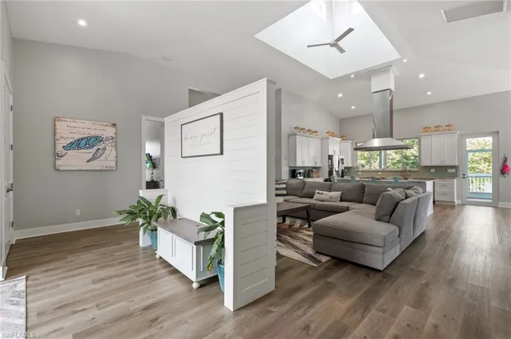 Natural light flows into Living room with high vaulted ceiling