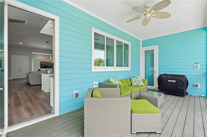 Screened in Deck featuring an outdoor living space, grilling area, and a ceiling fan