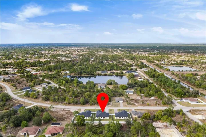 Aerial perspective of suburban area featuring a large body of water