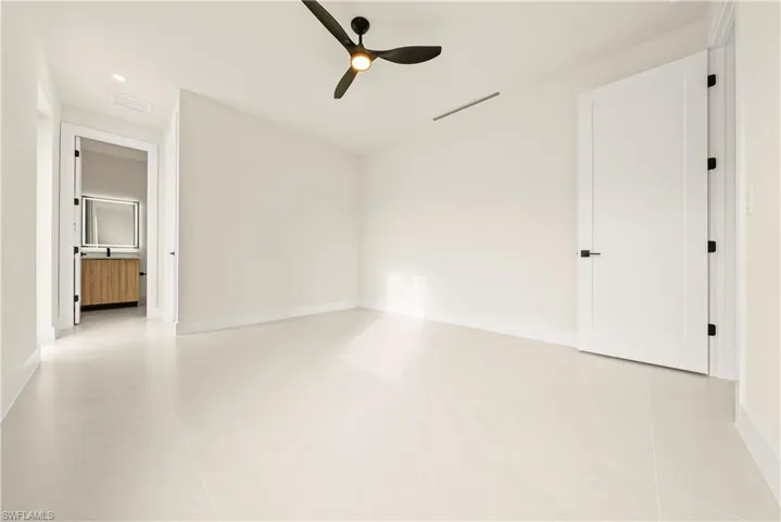 Unfurnished bedroom with a ceiling fan and baseboards