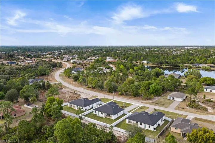 Aerial view of residential area featuring a tree filled landscape