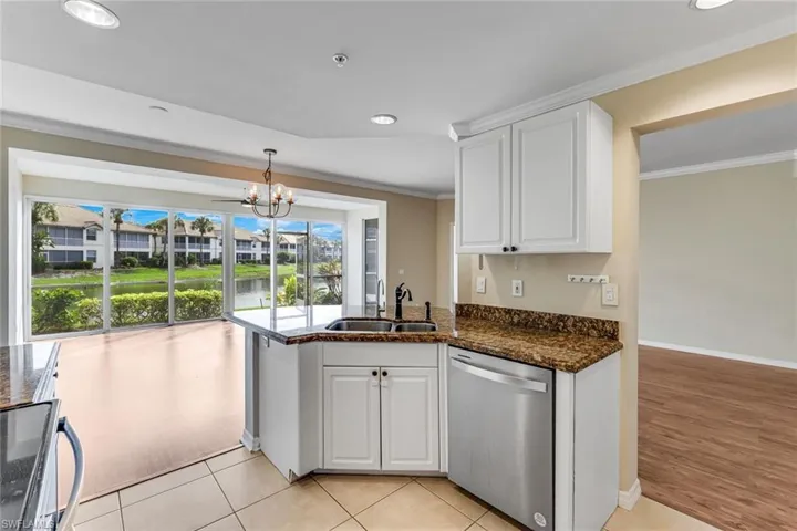 Kitchen featuring white cabinetry, a stainless steel dishwasher, and granite countertops