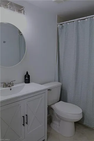 Full bathroom with vanity, a shower with curtain, and light tile patterned flooring