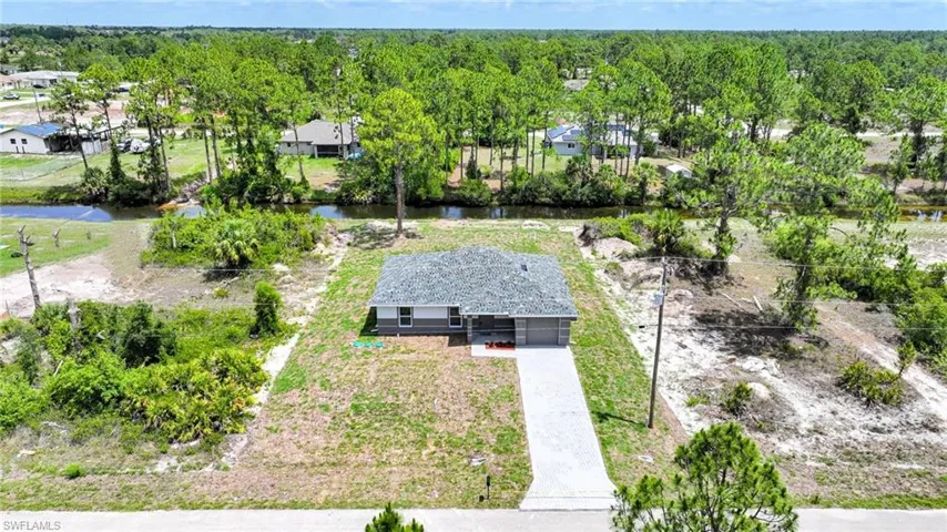 Amazing New Construction 3 Bedroom/2 Bathroom Home On A 1/4 Acre Canal Lot In Lehigh Acres! Fish From Your Own Back Yard!