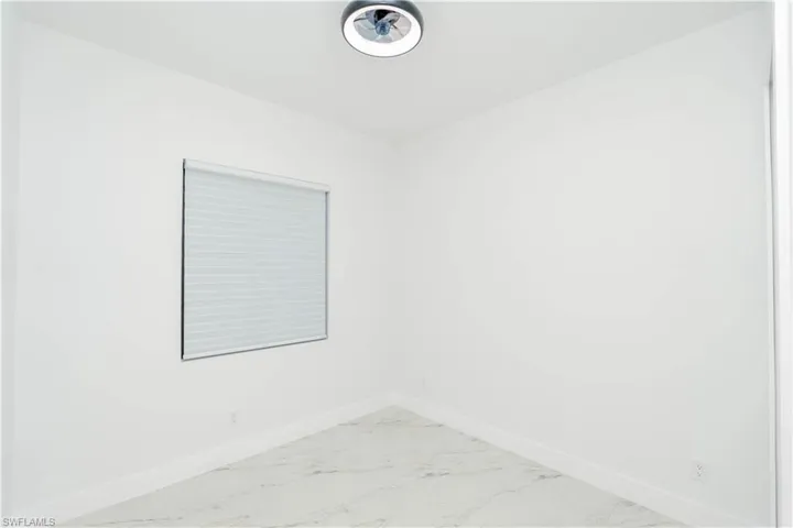 Empty room with baseboards and marble finish floors