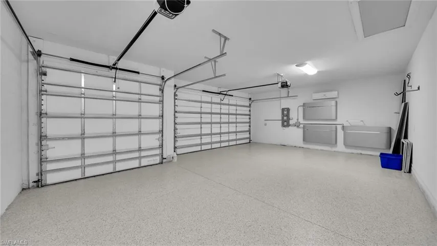 3 Car Garage with epoxy floor and ENPHASE SOLAR ENERGY SYSTEM  mounted on wall