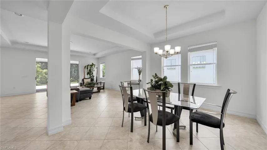 Formal Dining with tray ceiling leading into Great room living