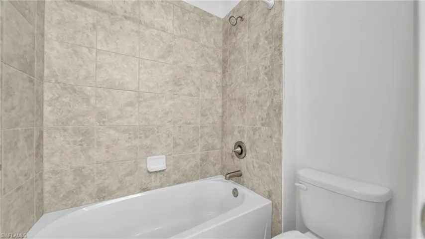 Full bath featuring toilet and shower / tub combination