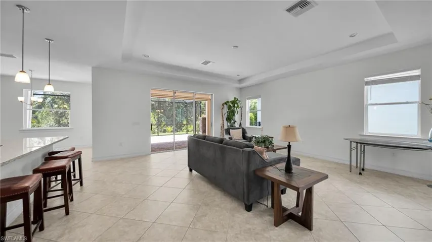 Great Room Living area with a Tall tray ceiling, Tile Floor leading to Lanai