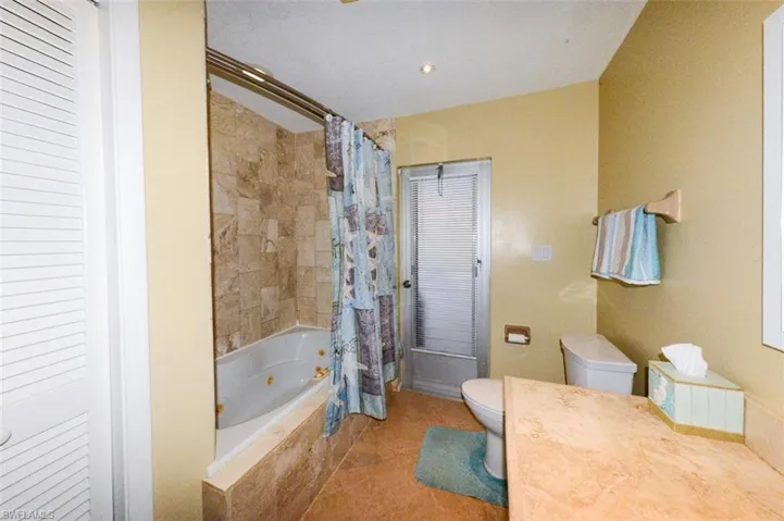 Guest bathroom featuring door to pol area