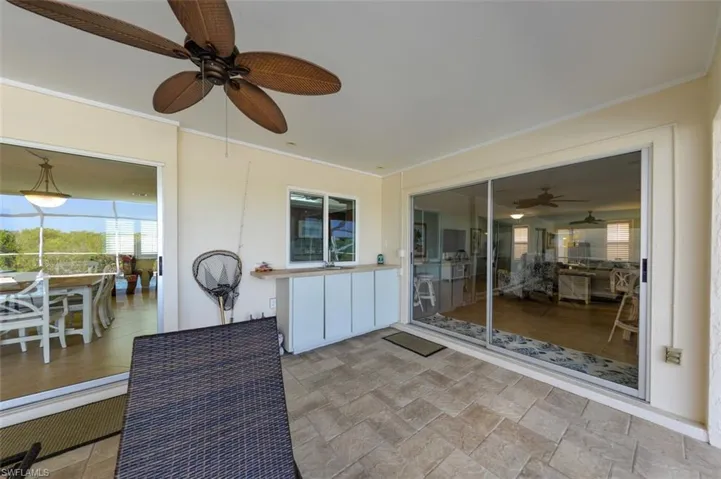 View of lanai with sliders to dining room, to dinette and pass through window to kitchen