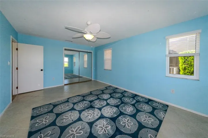 Guest bedroom featuring ceiling fan and plenty of natural light