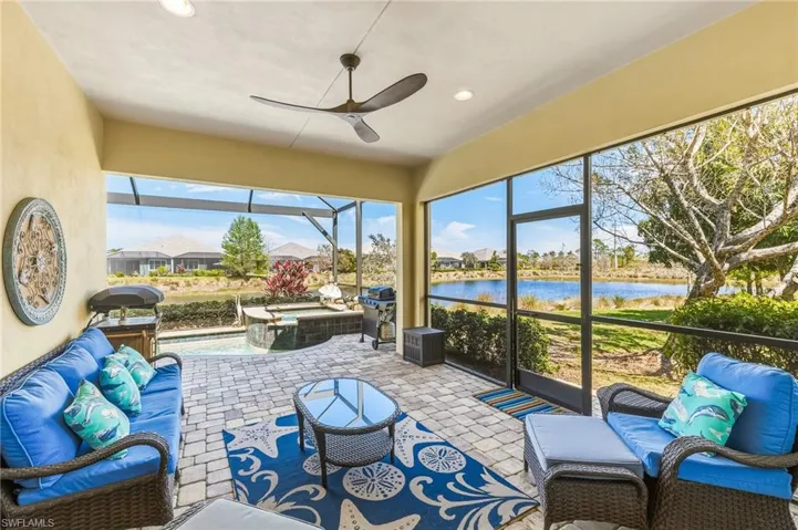 Sunroom / solarium with an outdoor hangout area, a ceiling fan, a residential view, and a hot tub