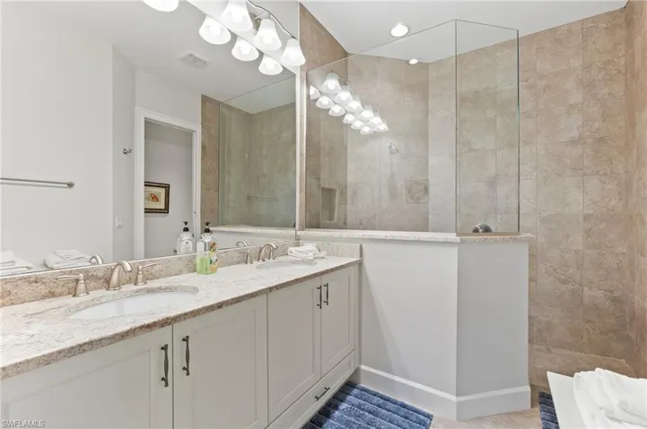 Bathroom featuring double vanity and walk in shower