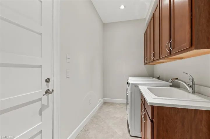 Laundry room featuring cabinet space, recessed lighting, and washer and dryer