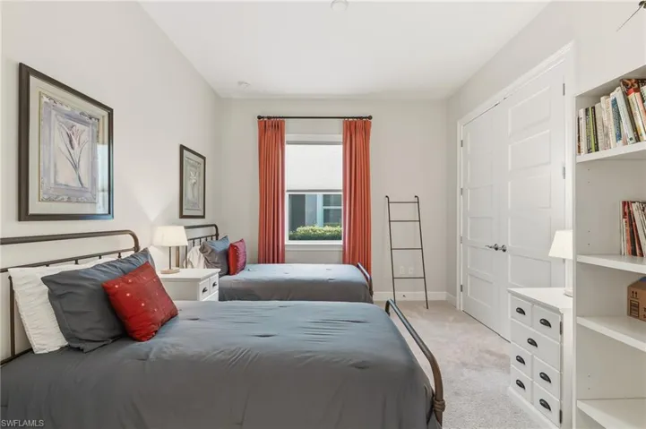 Guest Bedroom with light colored carpet and baseboards