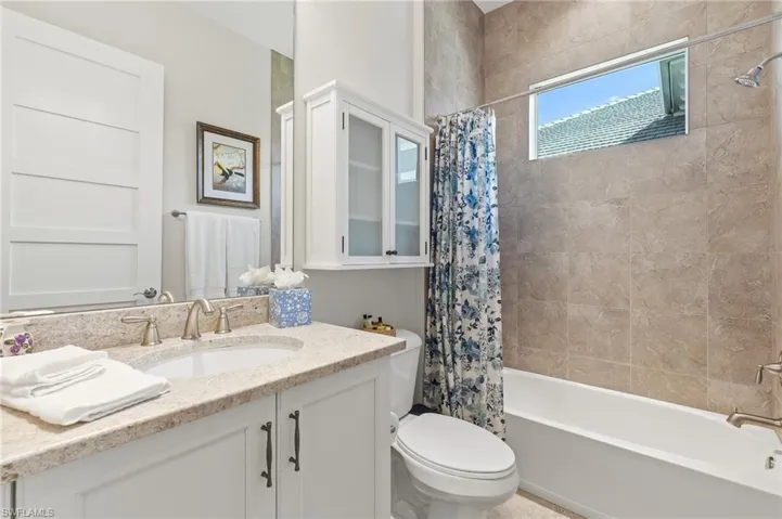 Bathroom featuring vanity and shower / bath combo