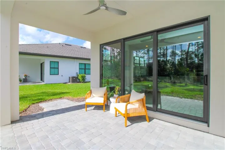 View of patio featuring ceiling fan and cooling unit