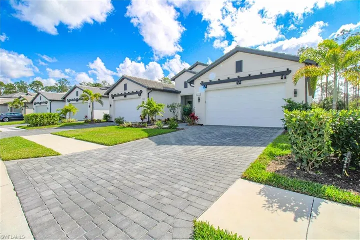 View of front of home featuring a front lawn and a garage