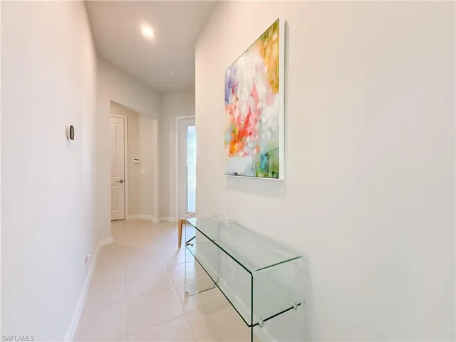 Hall featuring light tile patterned flooring