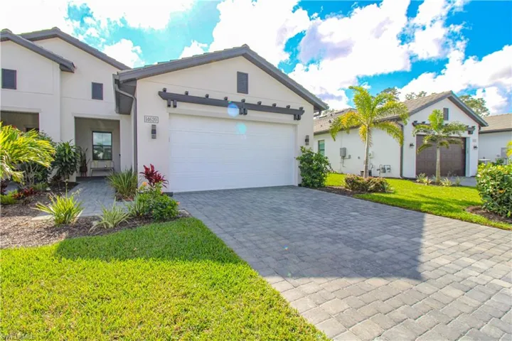 View of front of home with a front yard and a garage